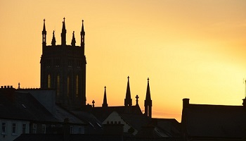 Silhouetted sunset sky with church tower