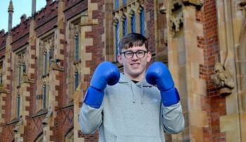 Peter wears his blue boxing gloves at the lanyon building