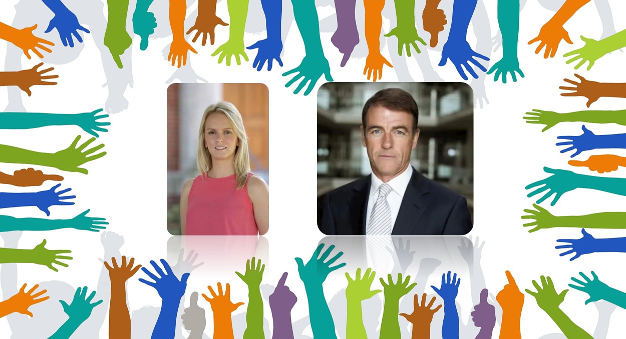 Male in dark jacket and tie and female in salmon coloured top against Volunteers' Week backdrop of colourful hands 