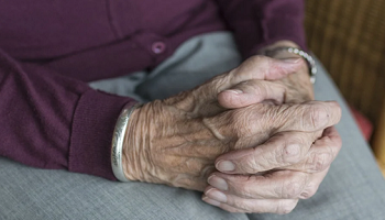 Hands of elderly person intertwined 