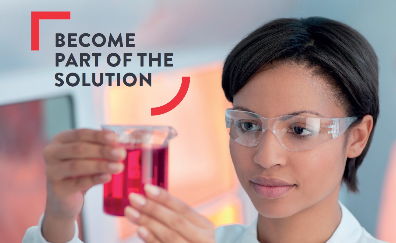 Female scientist in lab holding glass beaker of pink liquid; wording over image states Become part of the solution