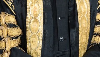 Black robes of Queen's University Chancellor with gold braiding 