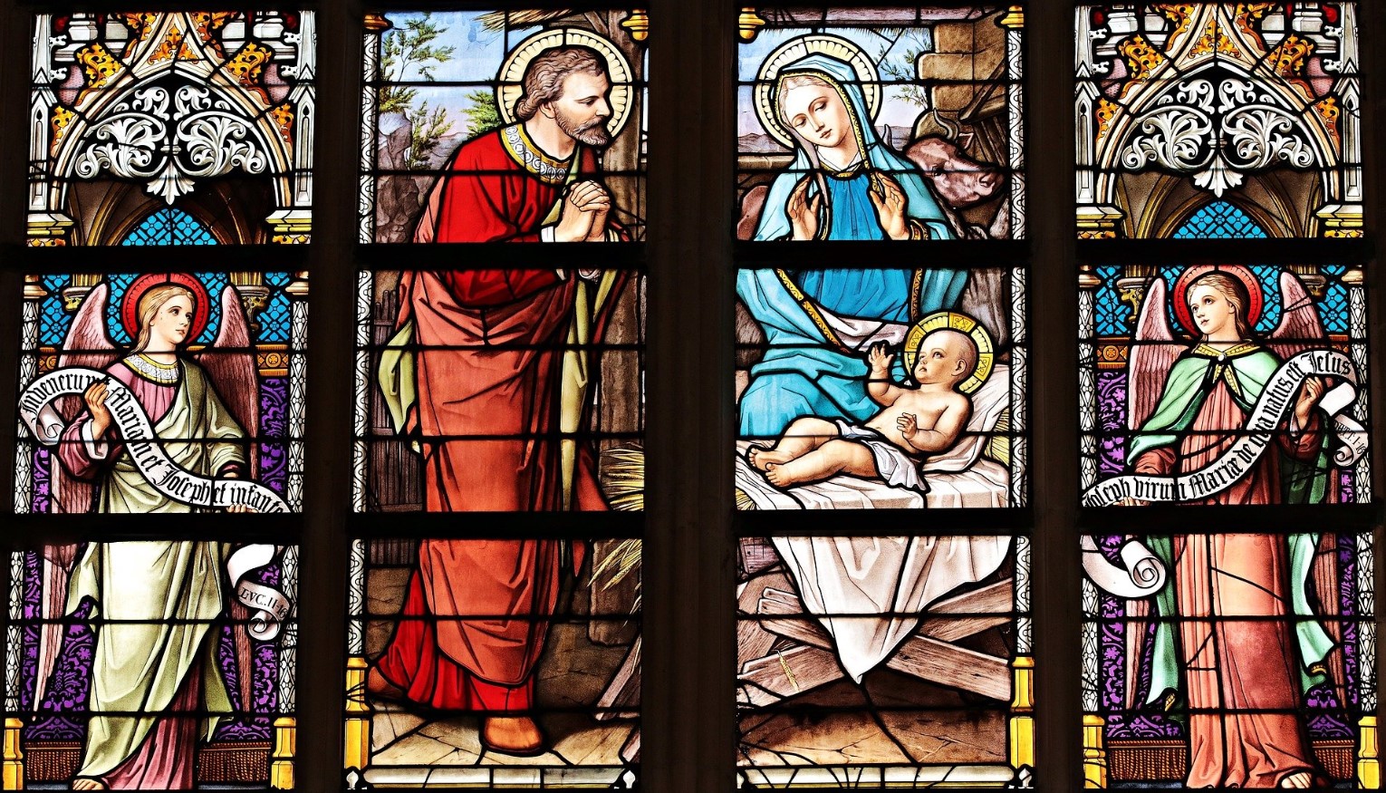 Stained glass church window showing biblical scenes
