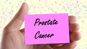 Hand holding post-it note with words prostate cancer written on it