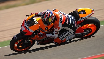 Jonathan Rea in bright orange, red and yellow leathers on motorbike racing