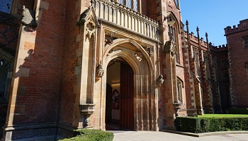 Front door of Queen's Lanyon Building bathed in sunshine