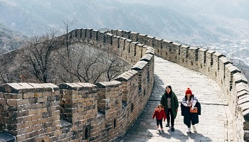 Three people walking on the Great Wall of China 