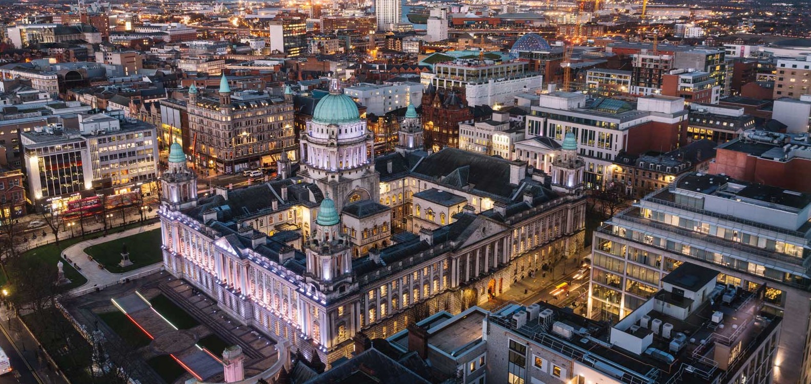 Aerial view of Belfast City Centre featuring City Hall at dusk