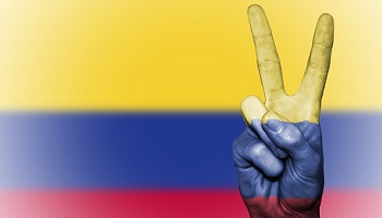 Columbia flag - yellow, blue and red horizontal stripes - with superimposed hand showing victory sign