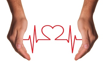 Hands either side of a red stylised heartbeat line illustration with heart shape in middle