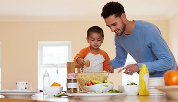 Man and young boy cooking in stylish kitchen