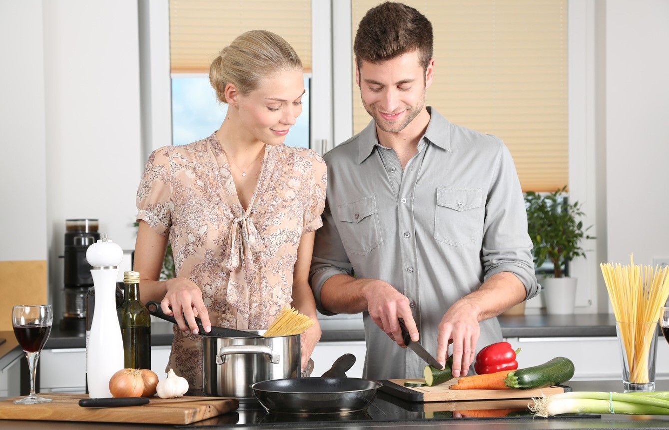Man and woman cooking in stylish kitchen