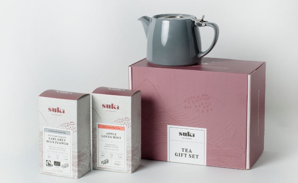 Grey teapot and boxes of Suki tea