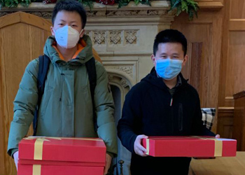 Students hold presents