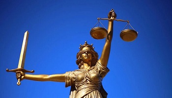 Statue of Justice blindfolded, holding scales and sword